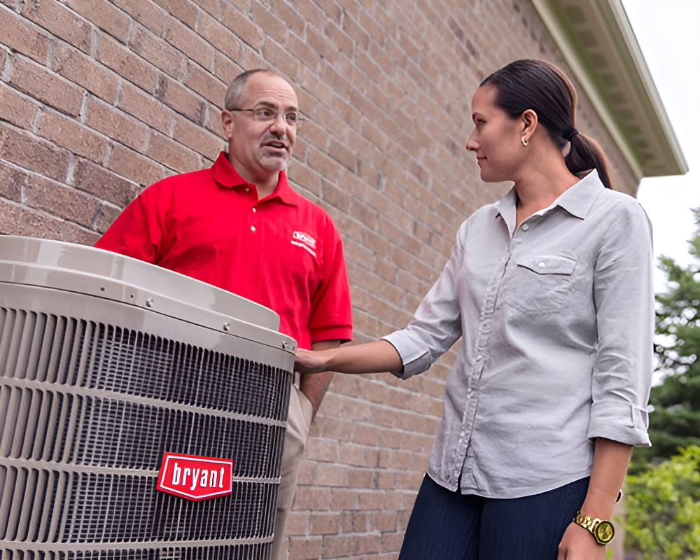 Two people beside outdoor cooling equipment